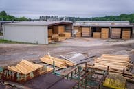 pexels-photo-12278576-12278576 A comprehensive view of an industrial lumber yard showcasing neatly stacked wood planks ready for distribution.